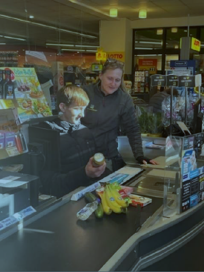 Foto eines Schülers der bei Edeka eine Kasse bedient